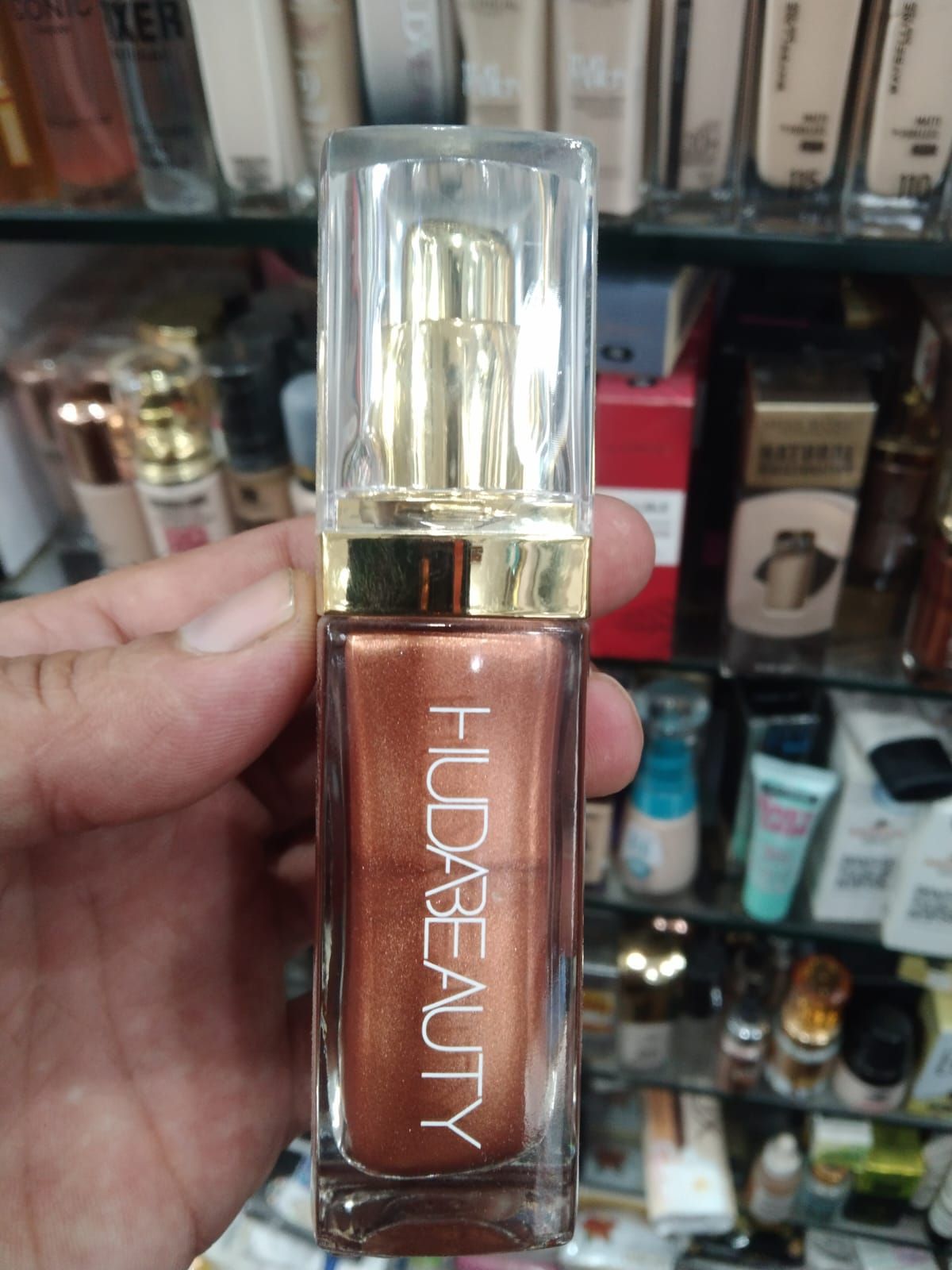 Huda Beauty N.Y.M.P.H. All Over Body Highlighter – Liquid Illuminator for Face, Body &amp; Legs – Water-Based, Long-Lasting Glow – 35 ml View Gallery - Pakistan